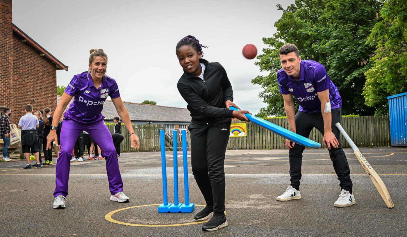 Ami Campbell and Matt Fisher with school students