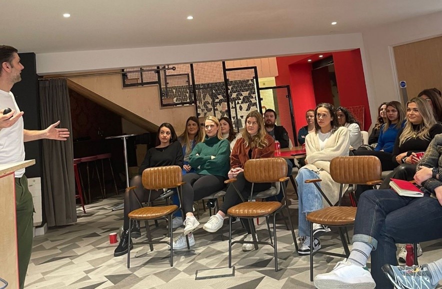 People sat watching a presentation