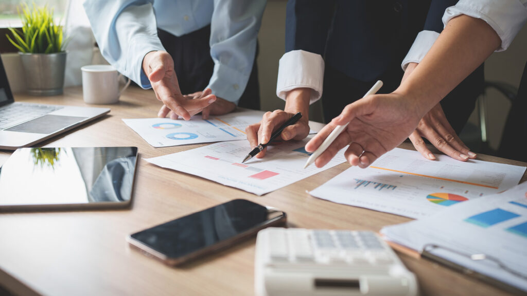 Close up of people's hands with pens