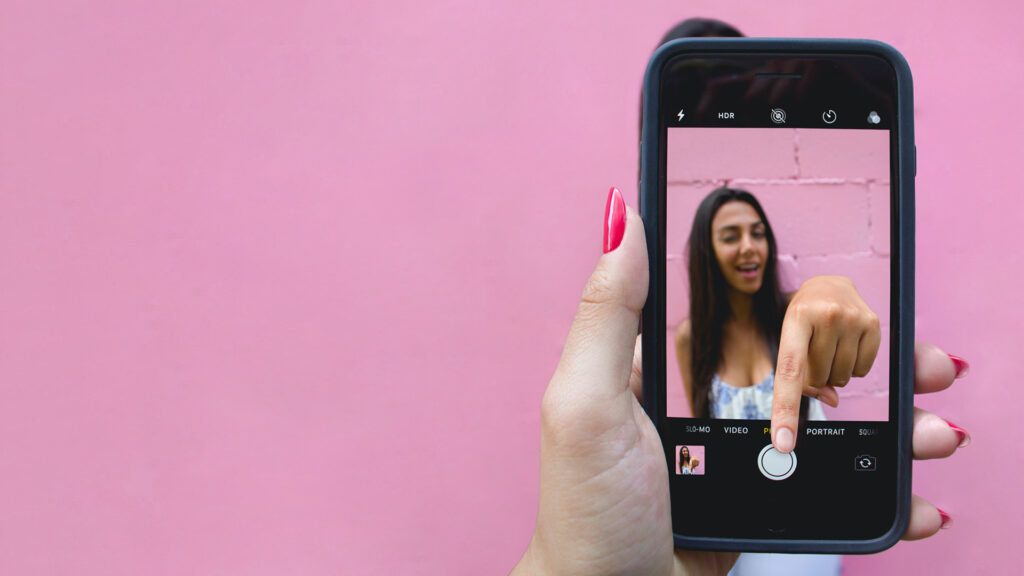 a persons hand holding a phone that is shooting a video
