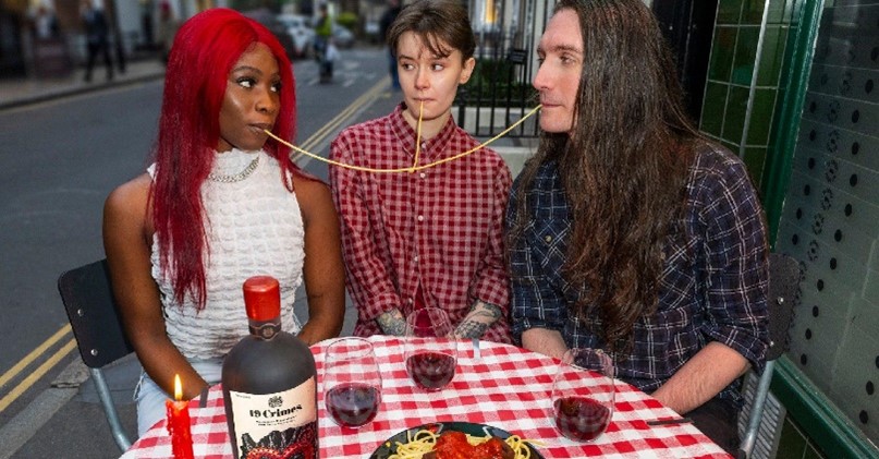 three people eating spaghetti